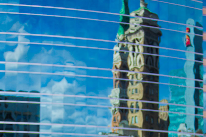 Image of downtown Oakland building reflected in a window. 